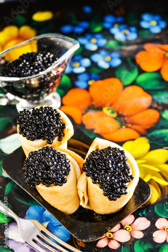 Russian Maslenitsa, pancakes with black caviar. Shrovetide, pancake week, carnival, shrove, pancake day. photo