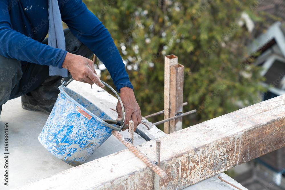 Civil worker grout cement in tube of sling steel in post tension slab system in construction