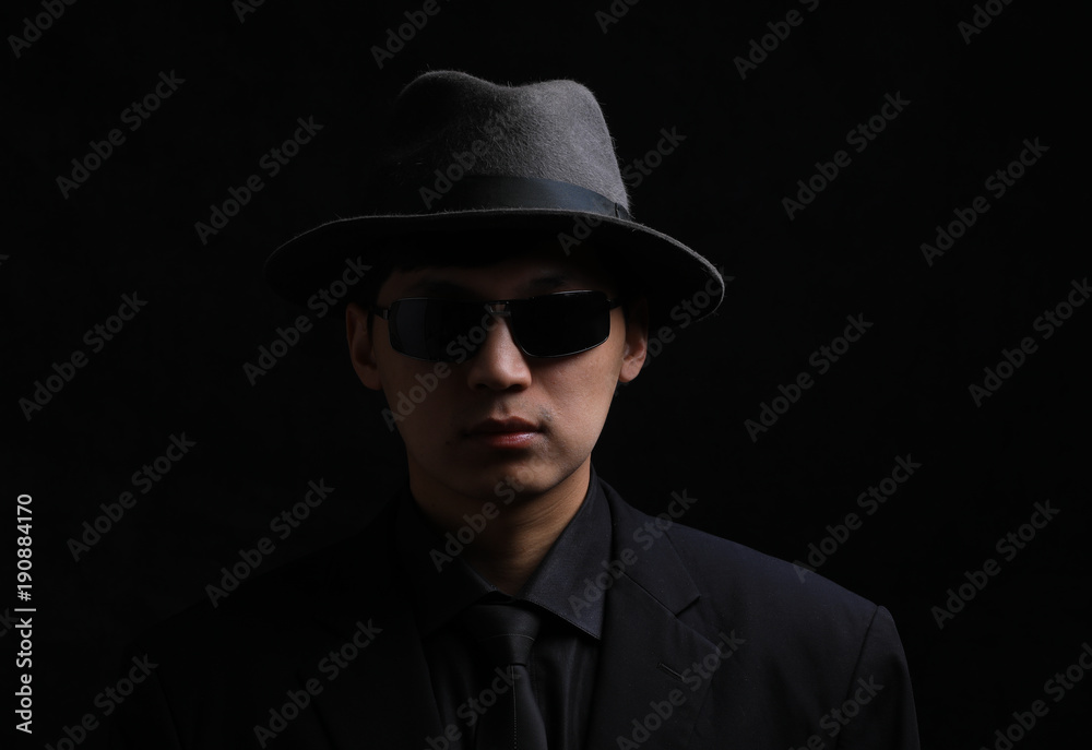 Portrait of a young Asian man. Close-up face on a black background Portrait of a young Asian man. Close-up face on a black background