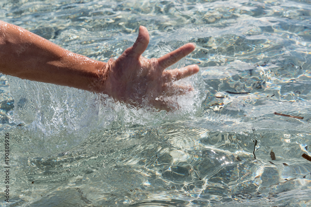 Hand and water splash.