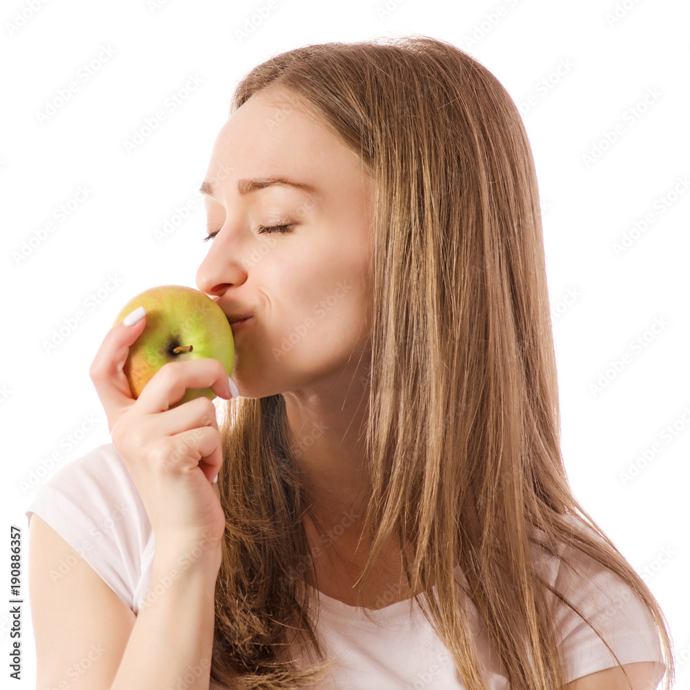 Beautiful young smiling woman holding an apple in her hands Beautiful young smiling woman holding an apple in her hands
