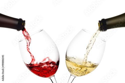 Fototapet red and white wine poured from a bottle into wine glass on white background, iso