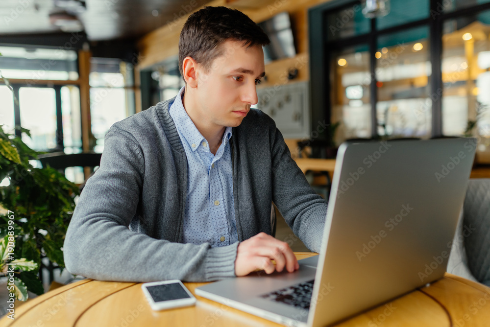 Startup business, software developer working on computer at cafe and thinking about work. Startup business, software developer working on computer at cafe and thinking about work.
