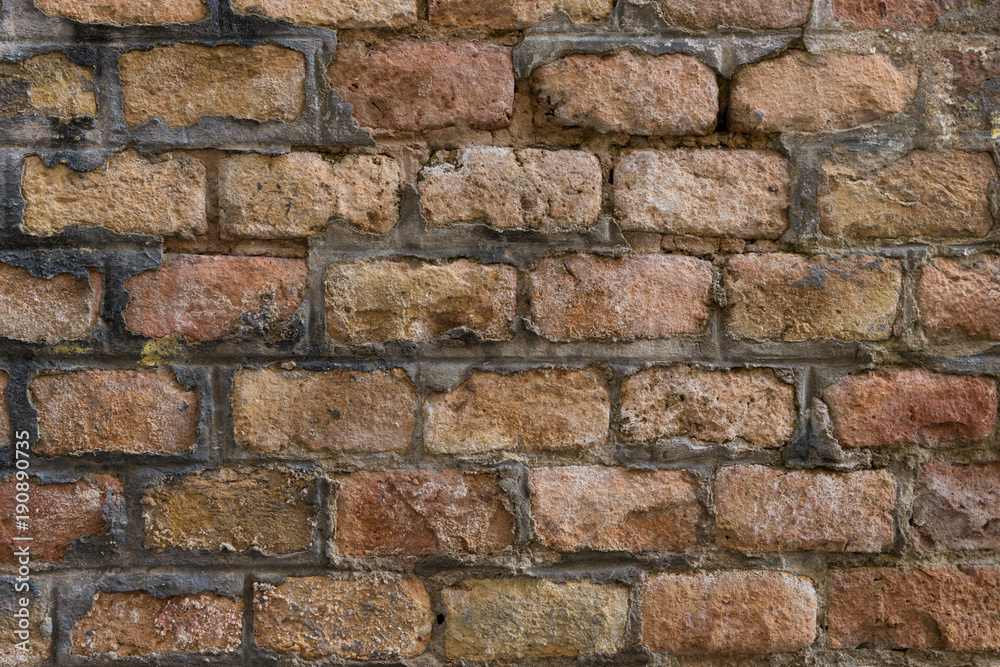 Very old pale red brick wall as background or wallpaper. Brick texture and pattern