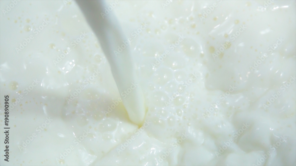 Pouring fresh milk into clean dishes in slow motion Pouring fresh milk into clean dishes in slow motion