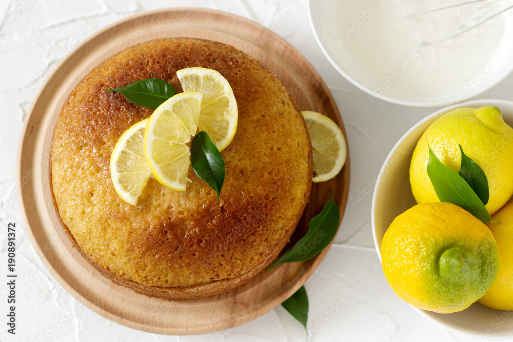 Lemon cake with whipped cream on a light background. Lemon cake with whipped cream on a light background.