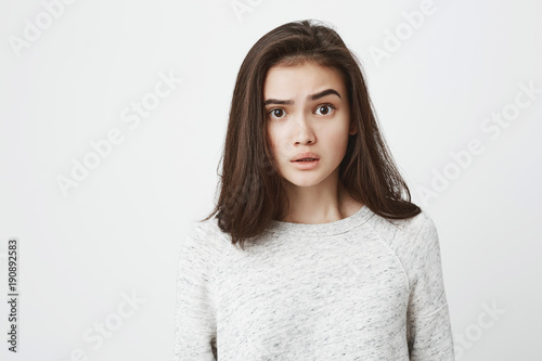 Close-up portrait of young attractive european adult brunette, lifting eyebrow with amazed and surprised expression. Student watches tv-show, being speechless because of plot twist © Cookie Studio