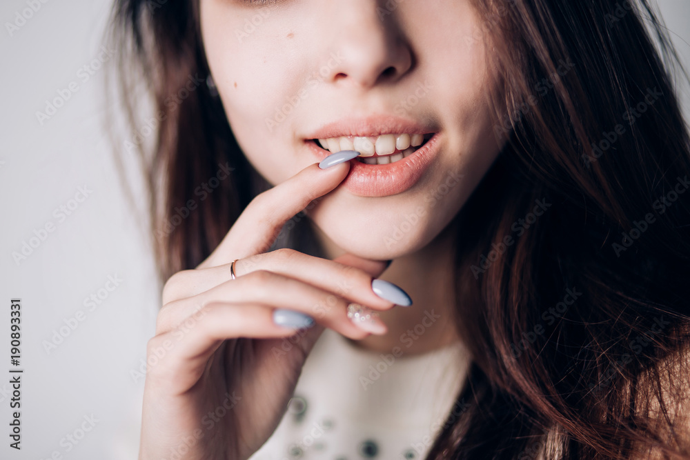 Close up of sexy woman with natural lips and beautiful manicure. Smile, emotion Close up of sexy woman with natural lips and beautiful manicure. Smile, emotion