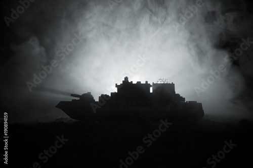 Silhouette of military war ship on dark foggy toned sky background.