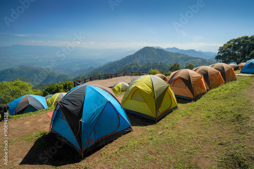 Fototapeta Naklejka Na Ścianę i Meble -  Camping tents on the top of mountain during sunrise at San pa kia to see Doi Luang Chiangdao, Chiang Mai, Thailand.