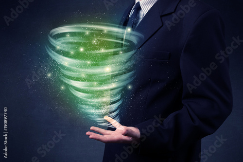 Businessman holding green tornado