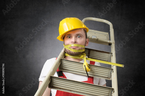 Konstfotografi Clumsy worker with measure tape