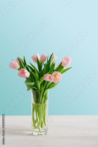 Pink tulips bouquet on blue background