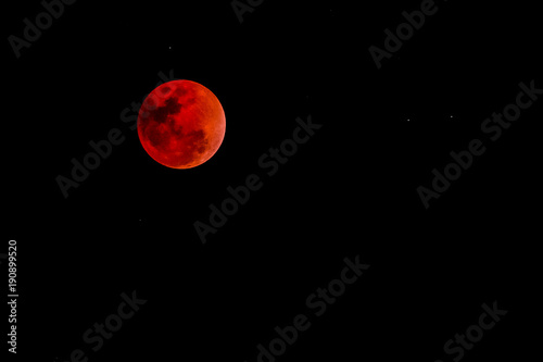 blood moon concept of a red full moon against a black sky