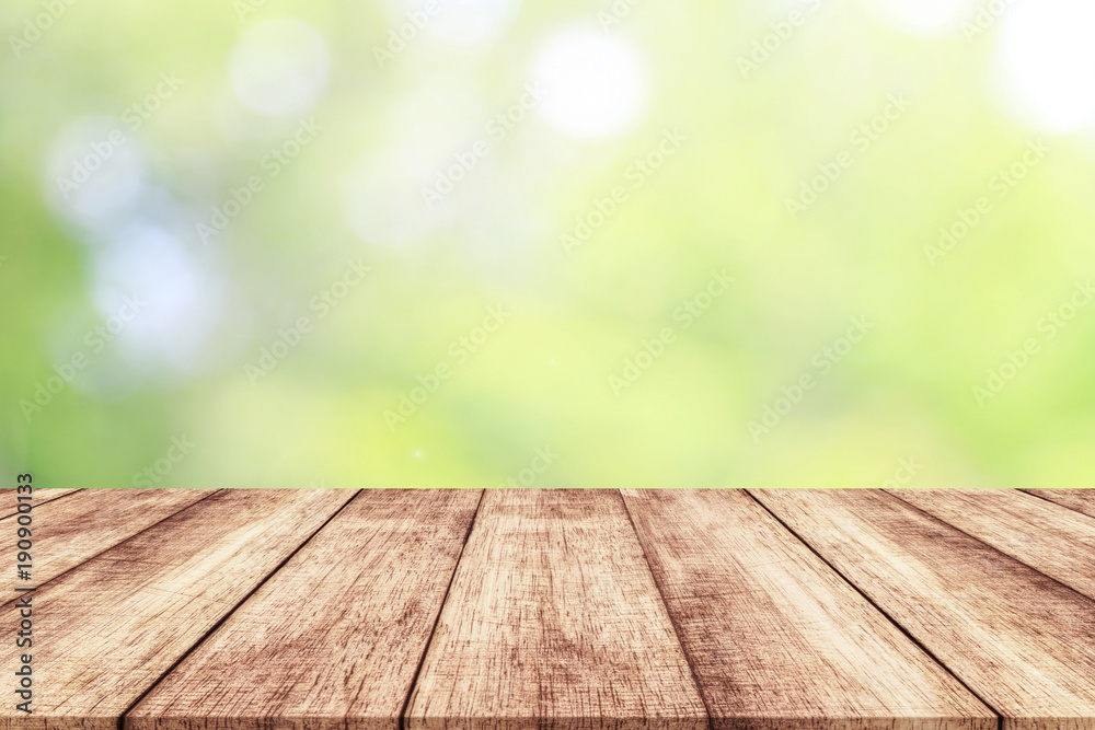 Wood table top on blur nature background with spring or summer