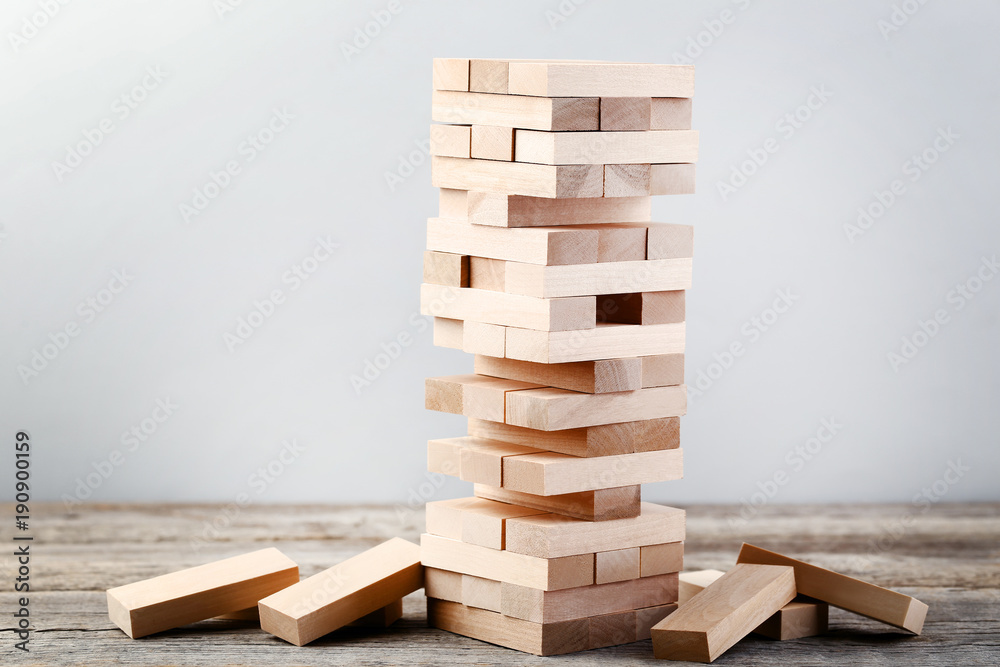 Wooden block tower game on grey table