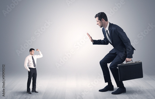 Giant businessman scared of small businessman