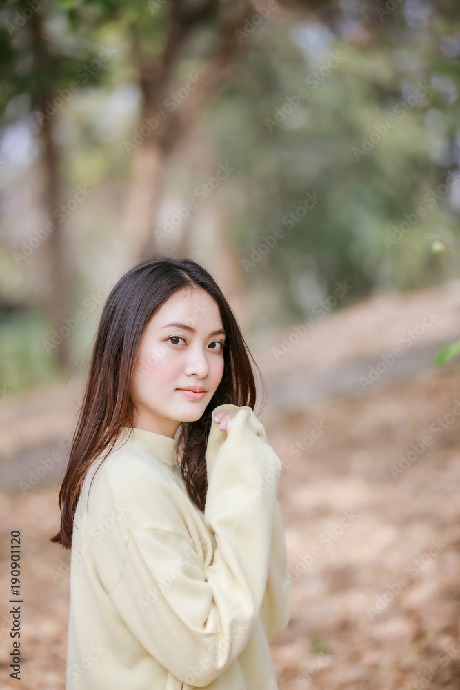 Beautiful Asian woman Smiling happy girl and wearing warm clothes winter and autumn portrait at outdoor in park Beautiful Asian woman Smiling happy girl and wearing warm clothes winter and autumn portrait at outdoor in park
