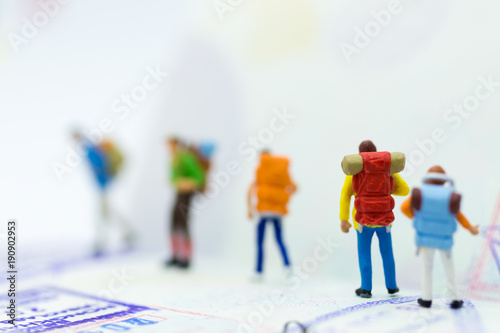 Miniature people : Backpacker group walking on passsport. Image use for travel, business concept.