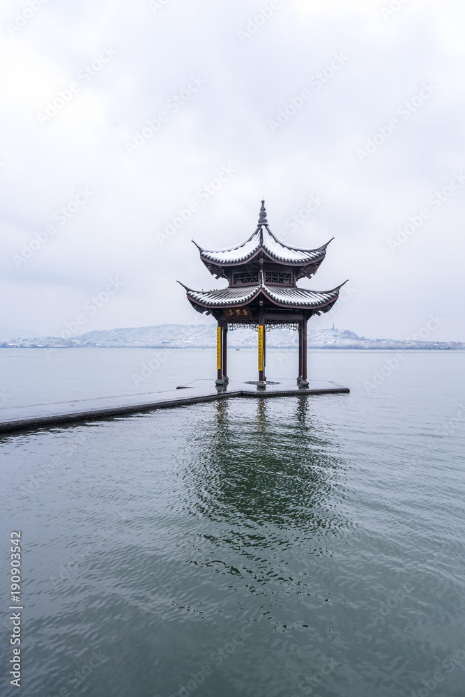 winter in hangzhou west lake covers snow,The chinese word in photo means “Jixian pavilion”，is a famous place