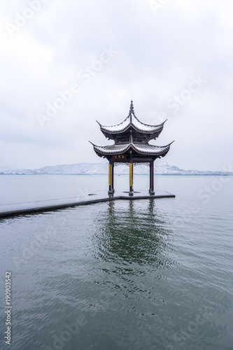 winter in hangzhou west lake covers snow,The chinese word in photo means “Jixian pavilion”，is a famous place