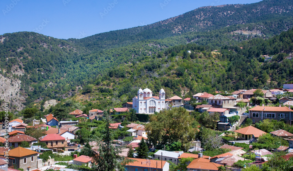 Mountain Village Pedoulas, Cyprus. View over roofs of houses, mountains and Big church of Holy Cross. Village is one of most picturesque villages of Troodos mountain range