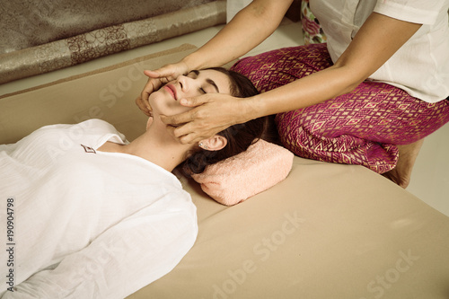 Asian young Girl get Thai style massage by Woman for body therapy