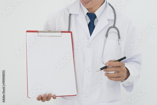 Close-up of a male doctor with lab coat in his office holding a clipboard. Healthcare and Medical concept.