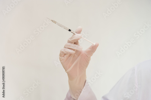 hand of doctor holding syringe on white background