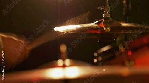 A closeup view of a hi-hat cymbal. Played with a drumstick. photo