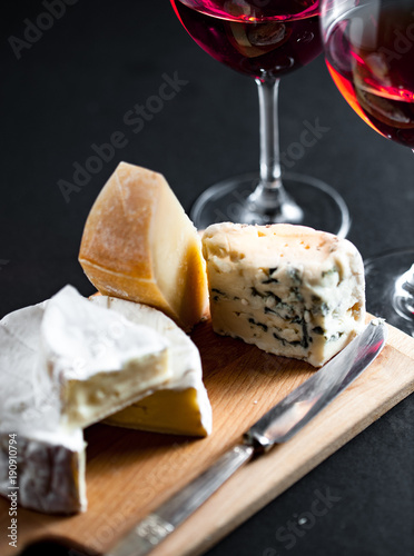 Cheese platter and two glasses of red wine photo