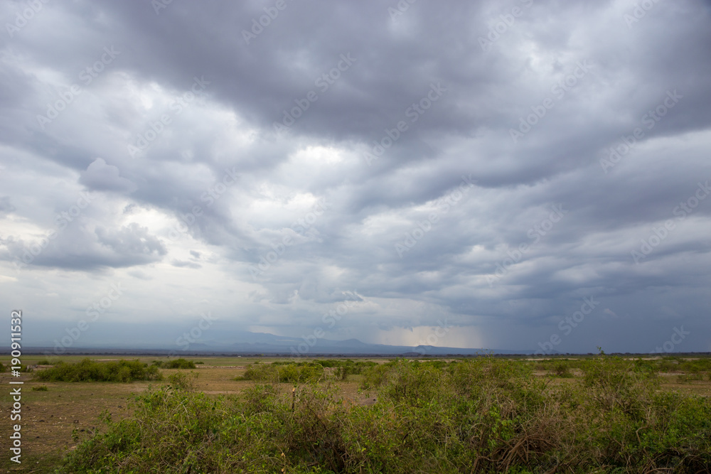 Dramatic cloudy sky over savanna in Kenya national park Dramatic cloudy sky over savanna in Kenya national park