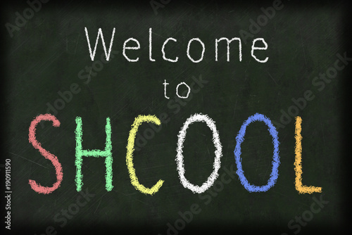 welcome to school spelled incorrectly with a chalk on a blackboard