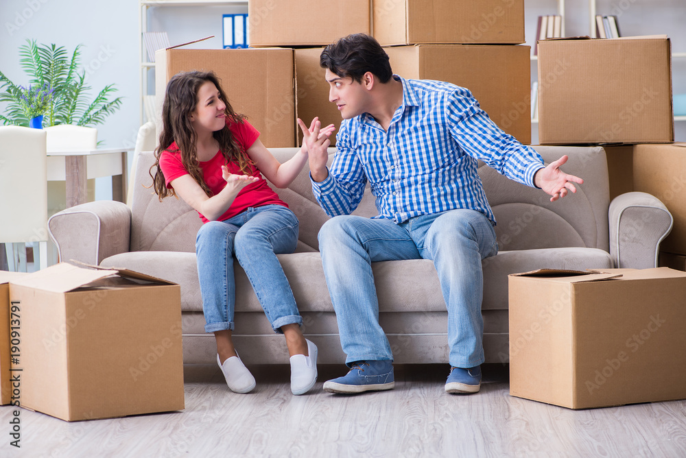 Young pair moving in to new house with boxes Young pair moving in to new house with boxes