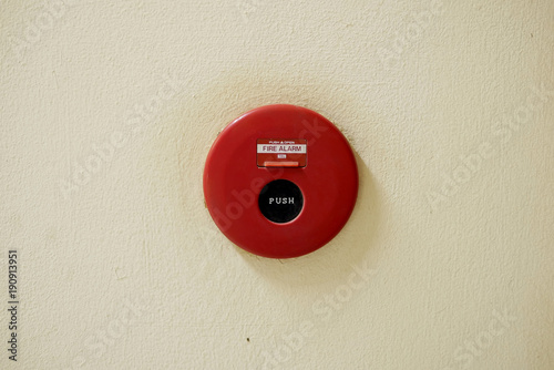 Red Fire Alarm on an Old White Painted Concrete Wall