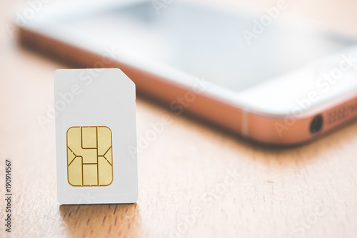Plakat Sim card put on wood table. Technology concept.