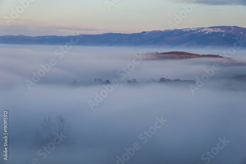 Beautiful mountain valley filled with fog in the Romanian Carpathians