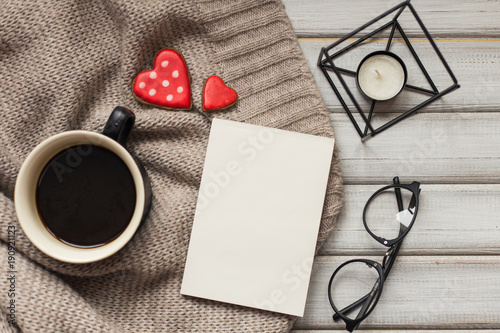 Box with a present to the Valentine's Day cookies in the shape of a heart and cups of black coffee photo