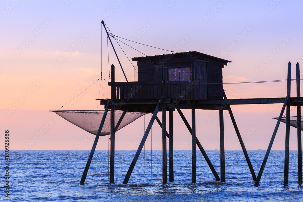 Beautiful view of fishing huts at sunset over the Atlantic Ocean Beautiful view of fishing huts at sunset over the Atlantic Ocean