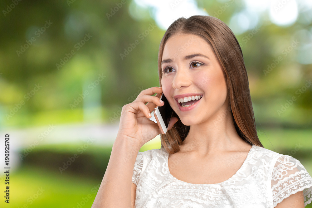 Young elegant woman talking on mobile phone Young elegant woman talking on mobile phone