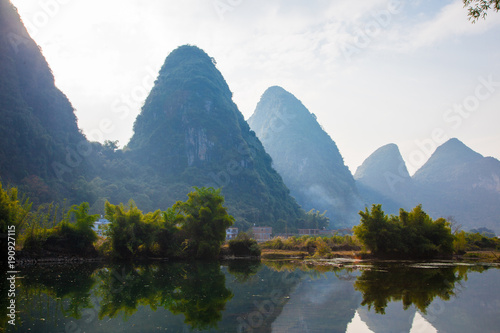 Beautiful landscape of karst mountains reflected in water  Yulong river in Yangshuo South China.