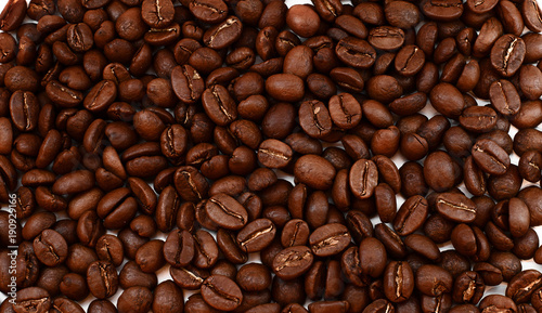 Background consisting of coffee beans. Many whole grains of Colombian coffee