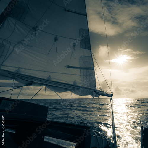 Yachting on sail boat during sunny dark weather