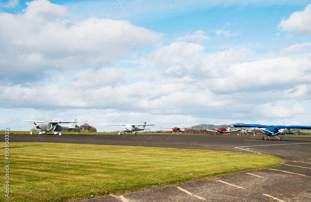 Overall view on airport with parked sport airplains