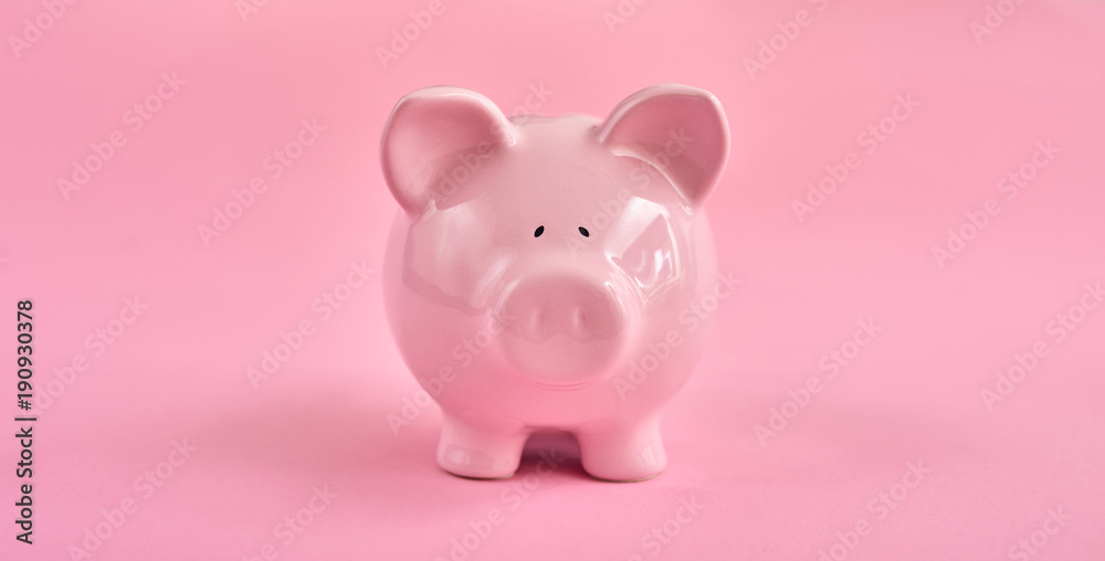 Pink piggy bank over pink background