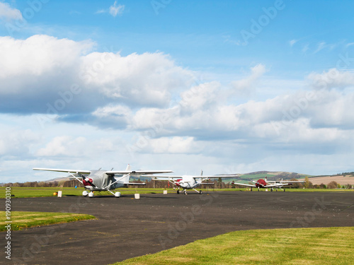 Small sport airplanes stay on runway in sunny day