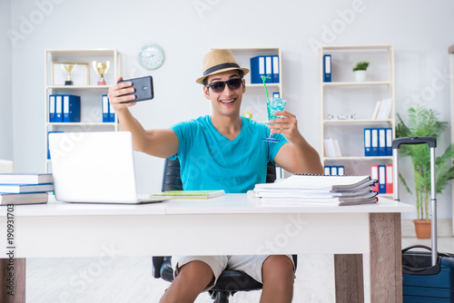 Businessman preparing for vacation in the office