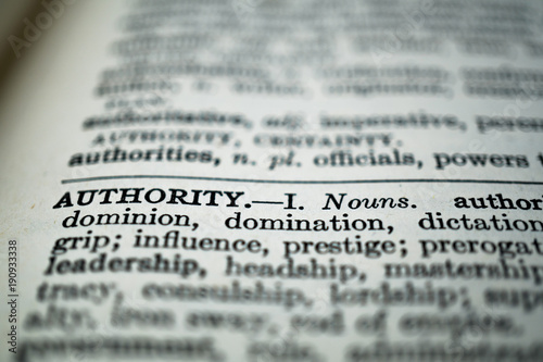 closeup of the word authority in the dictionary