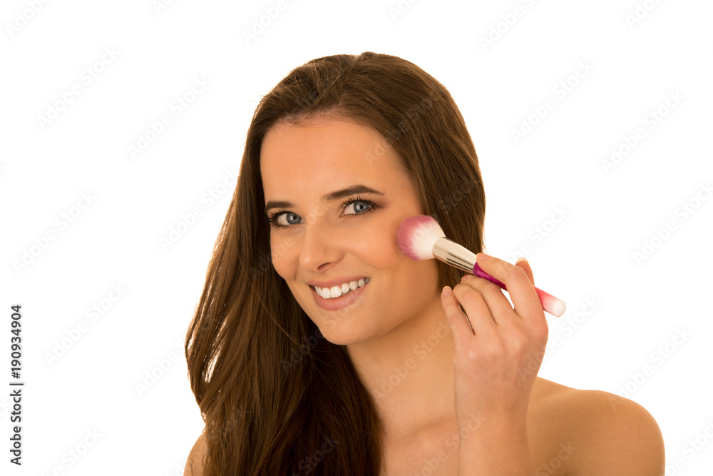 beautiful young caucasian brunette Woman applying makeup with a big brush beautiful young caucasian brunette Woman applying makeup with a big brush