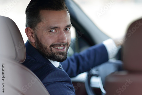 Close-up of a businessman sitting at the wheel of a car © ASDF